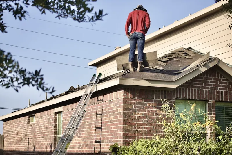 Professional roofer working on a residential roof in Oceano